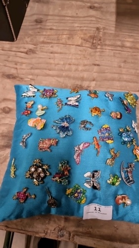 Cushion of brooches