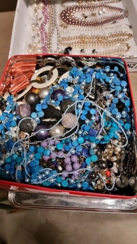 Tin of costume jewellery including some spares and repair