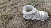 Stone boot garden statue