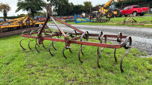 Front mounted spring tine harrow