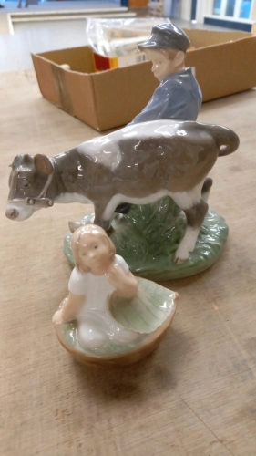 2 x Royal Copenhagen figures, Thumbelina in Nutshell Bed no. 4374 and Boy with Calf no. 772