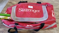 Slazenger cricket bag, including 2 pairs of batting gloves, batting pads, cricket balls, also wicket keeping gloves. Nearly new size 7 cricket shoes.