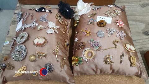 2 x cushions of brooches