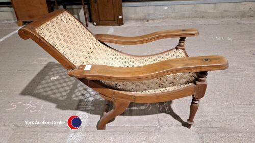 Original vintage Indian veranda chair, teak with rattan seat. Bought in Delhi and imported back to the UK in the 90's. In good condition though in need of a little maintenance on one of the arms.