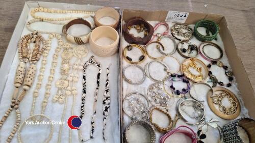 Tray of bangles and bracelets with another of bone and ivory-coloured jewellery