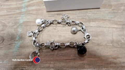 Silver 925 charm bracelet with 7 silver charms.