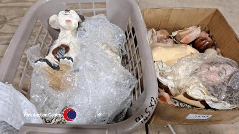 Box of doll parts and pair of dog ornaments