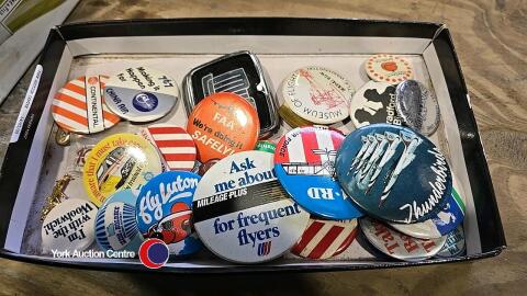 Tray of vintage advertising pin badges