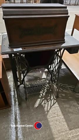 Single vintage sewing machine on ornate cast iron table