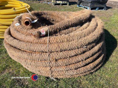 Roll of wrapped 60mm brown perforated draw pipe