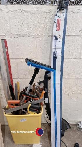 Box of assorted wood saws, spirit levels and other tools