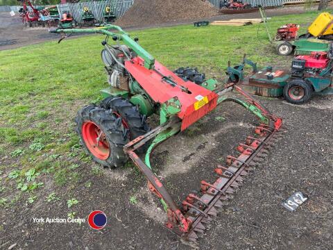 Petrol engined wide section grass cutter twin wheels