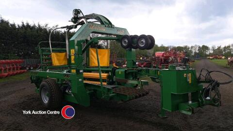 McHale 998 wrapper with round bale and static wrapping kits, controls and manuals in office, 2014