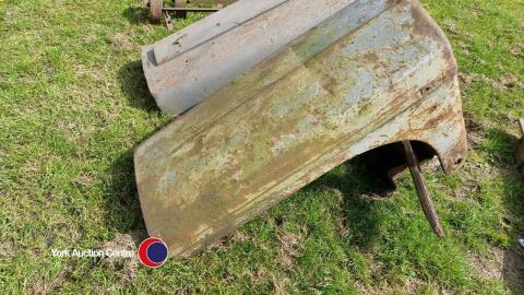 Grey Massey Ferguson bonnet with part of axle attached