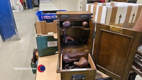 Vintage wooden pipe cupboard with pipes