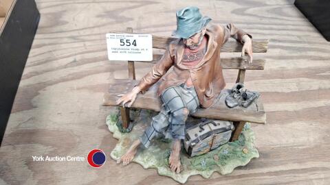 Capodimonte Tramp on a seat with suitcase