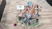 Capodimonte Tramp on a seat with suitcase