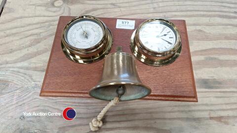 Clock and barometer and bell mounted on wooden board