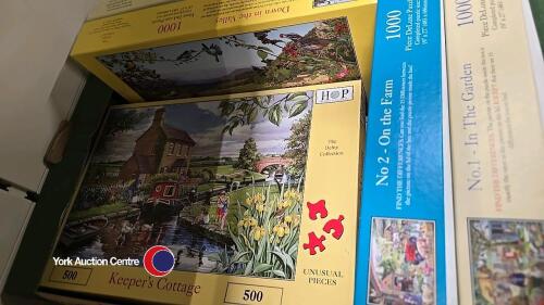 Box of assorted jigsaw puzzles
