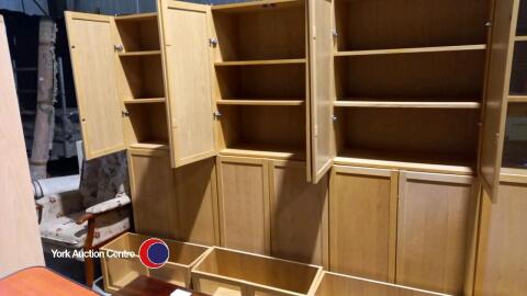 Tall bookcase with wooden doors and glass door top
