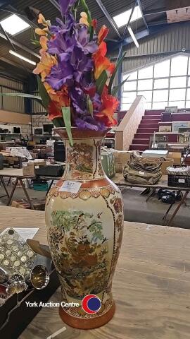 Tall vase with artificial gladioli