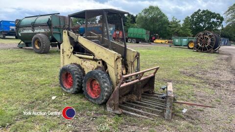 Hydra-Mac 11c skidsteer with muck fork and bale spike, engine turns, strong hydraulics