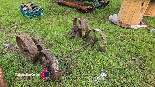 Pair of axles from a hayrack with cast iron wheels