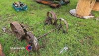 Pair of axles from a hayrack with cast iron wheels