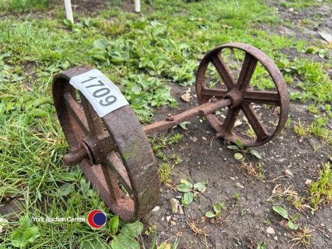 2 x small cast iron wheels on an axle
