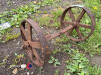 2 x small cast iron wheels on an axle - 2