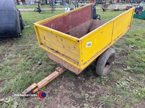 Small manual tip trailer for towing behind ride on mower