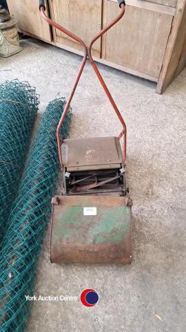 Old push lawnmower and wire fencing