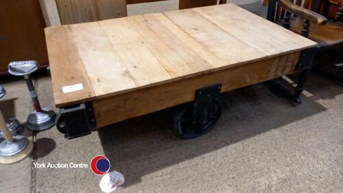 Industrial style cast iron and wood coffee table on wheels