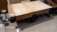 Industrial style cast iron and wood coffee table on wheels