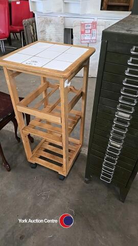 Tiled top shelving unit on wheels