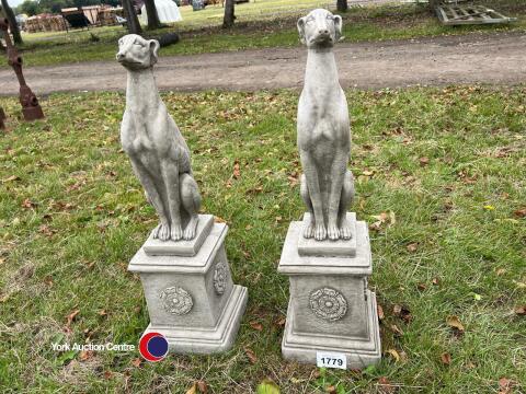 Pair of stone whippets on plinths