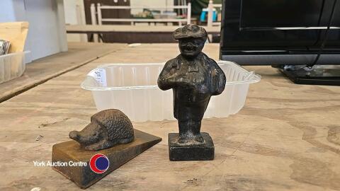 2 x cast iron door stops - man and hedgehog