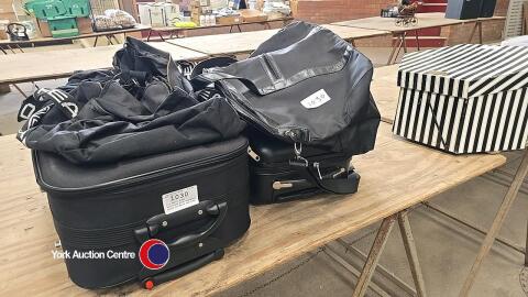 2 x small black suitcases plus assorted black holdalls and bags