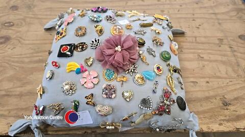 Cushion full of brooches