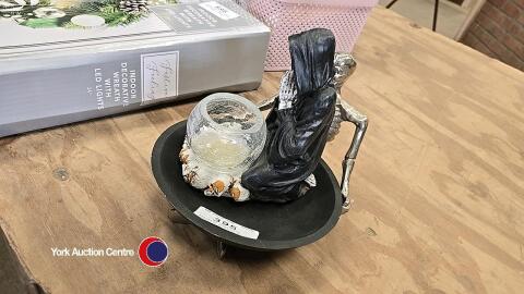 Skeleton bowl plus skeleton holding glass bowl