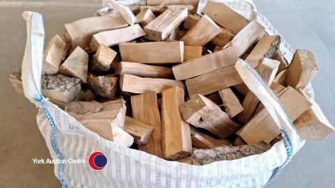 Barn dried hardwood logs in vented bulk bag